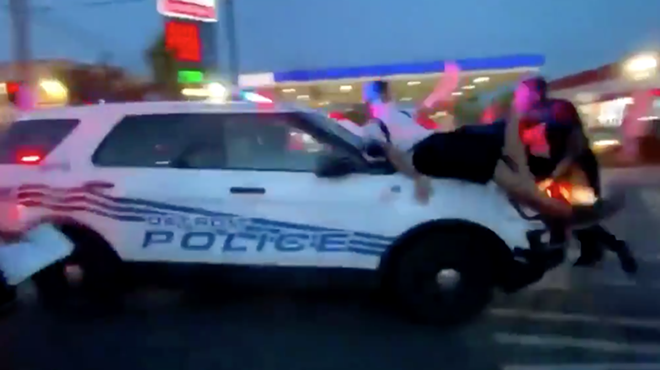 Screen grab from a video of a police car plowing through a group of protesters.