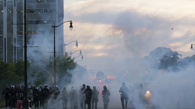 Detroit police deploy tear gas and rubber bullets as protesters flee.