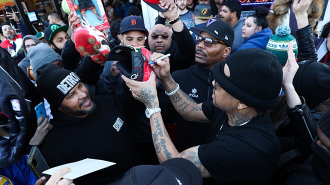 Allen Iverson signs merch on a visit to Michigan cannabis dispensaries.