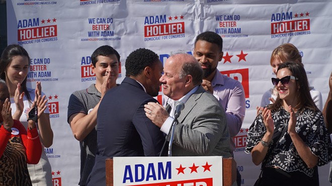 Mayor Mike Duggan (right) embraces state Sen. Adam Hollier at a news conference.