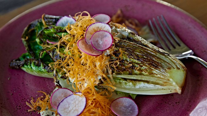 Charred romaine with bottarga dressing, mimolette, and radish from Coeur.