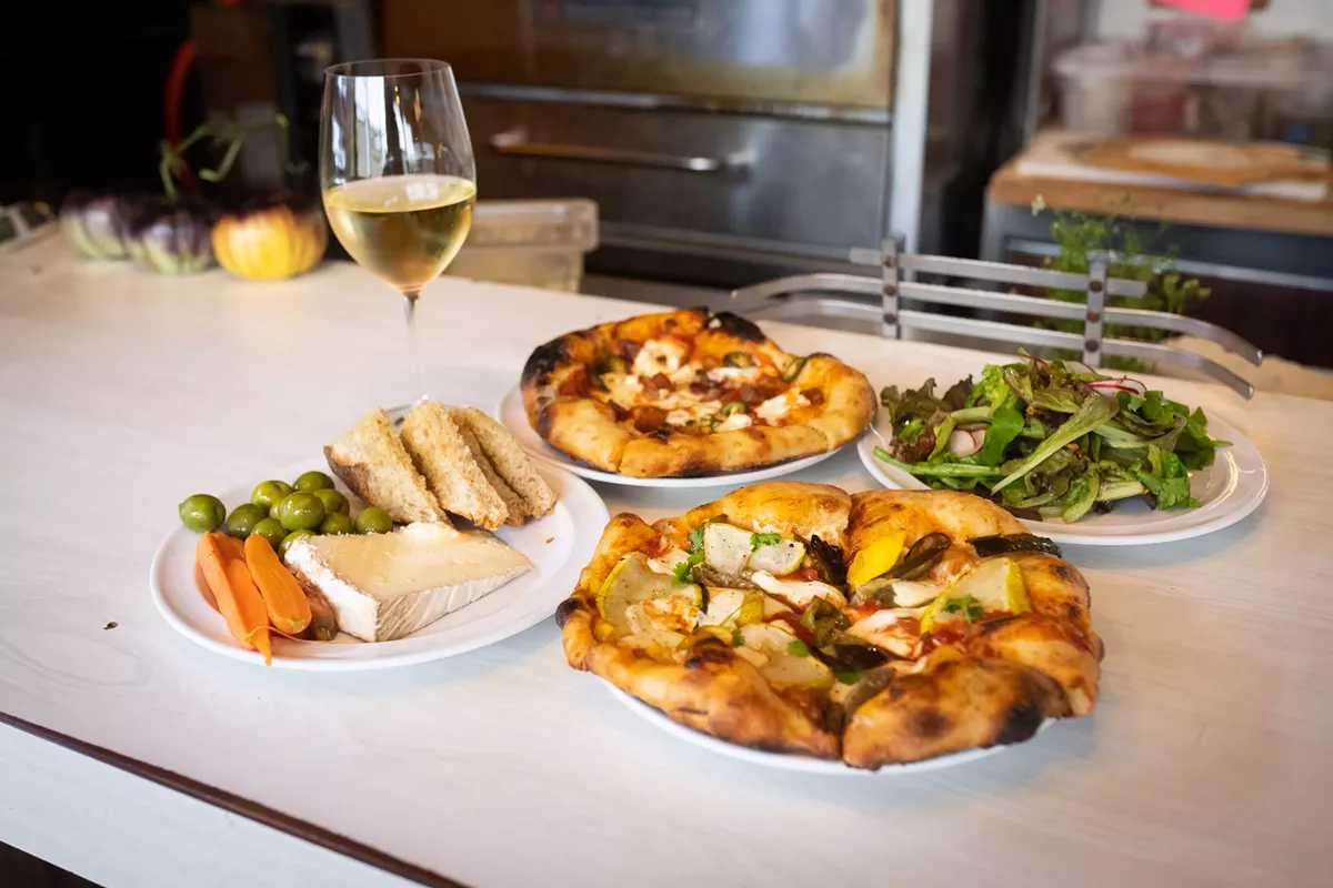 Image: Rose's dinner menu is short and changes each weekend — typically two pizzas, one with meat and one without, along with some combination of salads, “snack plates,” soup, and dessert.