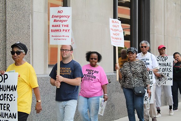 A coalition of activists protests outside the Detroit Water & Sewerage Department’s office in downtown Detroit on Friday, June 6. - Ryan Felton/Metro Times