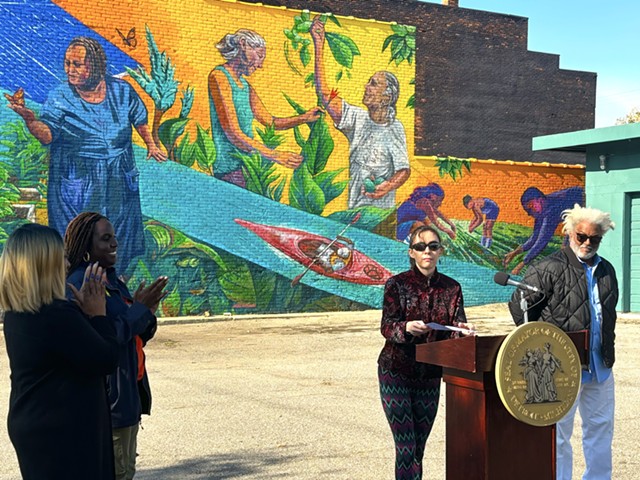 Nicole Macdonald (center right) at the celebration of her new mural, the 200th installation in Detroit's City Walls program. Activist Wayne Curtis (far right) is depicted in the mural.