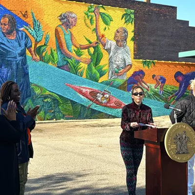 Nicole Macdonald (center right) at the celebration of her new mural, the 200th installation in Detroit's City Walls program. Activist Wayne Curtis (far right) is depicted in the mural.