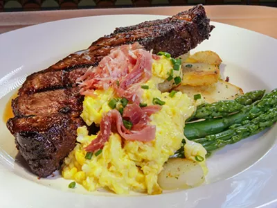 A rib chop, potatoes, asparagus, and corn from Brentwood Grille.