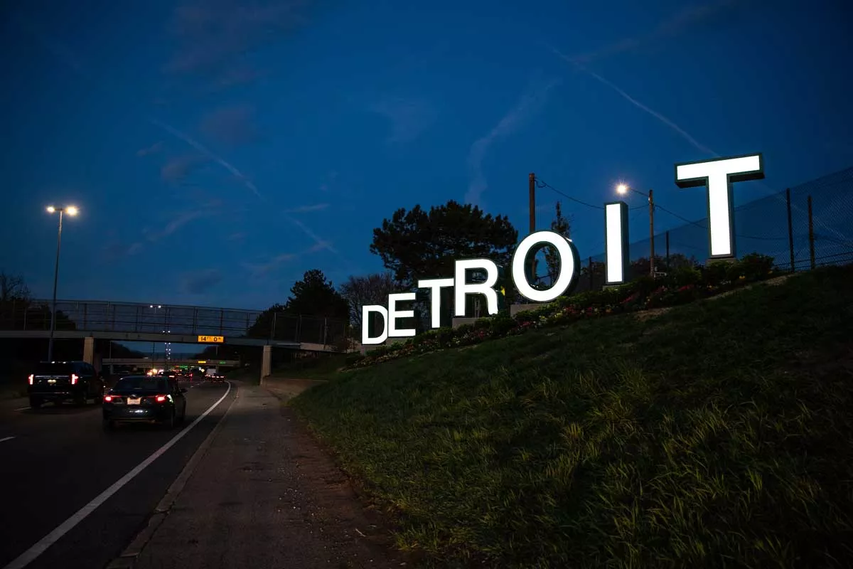 Image: The large Detroit sign illuminated at night.