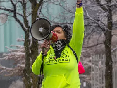 A person wears a mask that says "Abolish the Police" at a gathering of Detroiters reacting to the news that former Minneapolis police officer Derek Chauvin was found guilty on all counts for the murder of George Floyd.