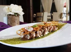 Pork tenderloin with five-herb pesto, goat cheese, chocolate wild mushrooms and potato cage, from Jefferson House in Detroit. - Robert Widdis