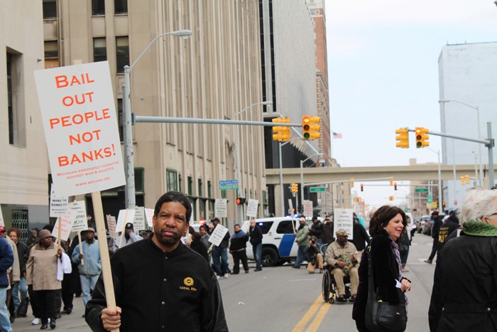 Retirees and supporters gathered outside of the Theodore Levin Federal Courthouse in downtown Detroit on Tuesday, April 1 to protest Detroit Emergency Manager Kevyn Orr’s proposed bankruptcy-exit plan, which calls for cuts to monthly pension checks. - Photo by Ryan Felton.
