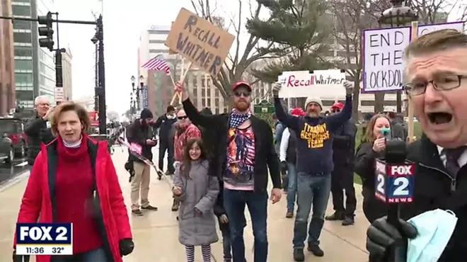 Royal Oak City Commissioner Kim Gibbs, in red, was spotted at Operation Gridlock. She could be seen repeatedly leaping out of the camera frame in a Fox 2 segment.