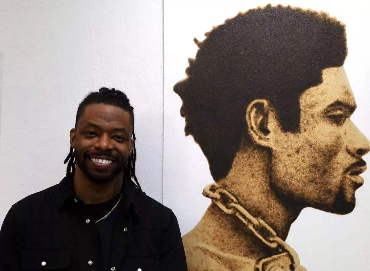 Image: Emerging artist Terrell Anglin uses wood burning and mixed media techniques to connect the past and present of the African American experience.