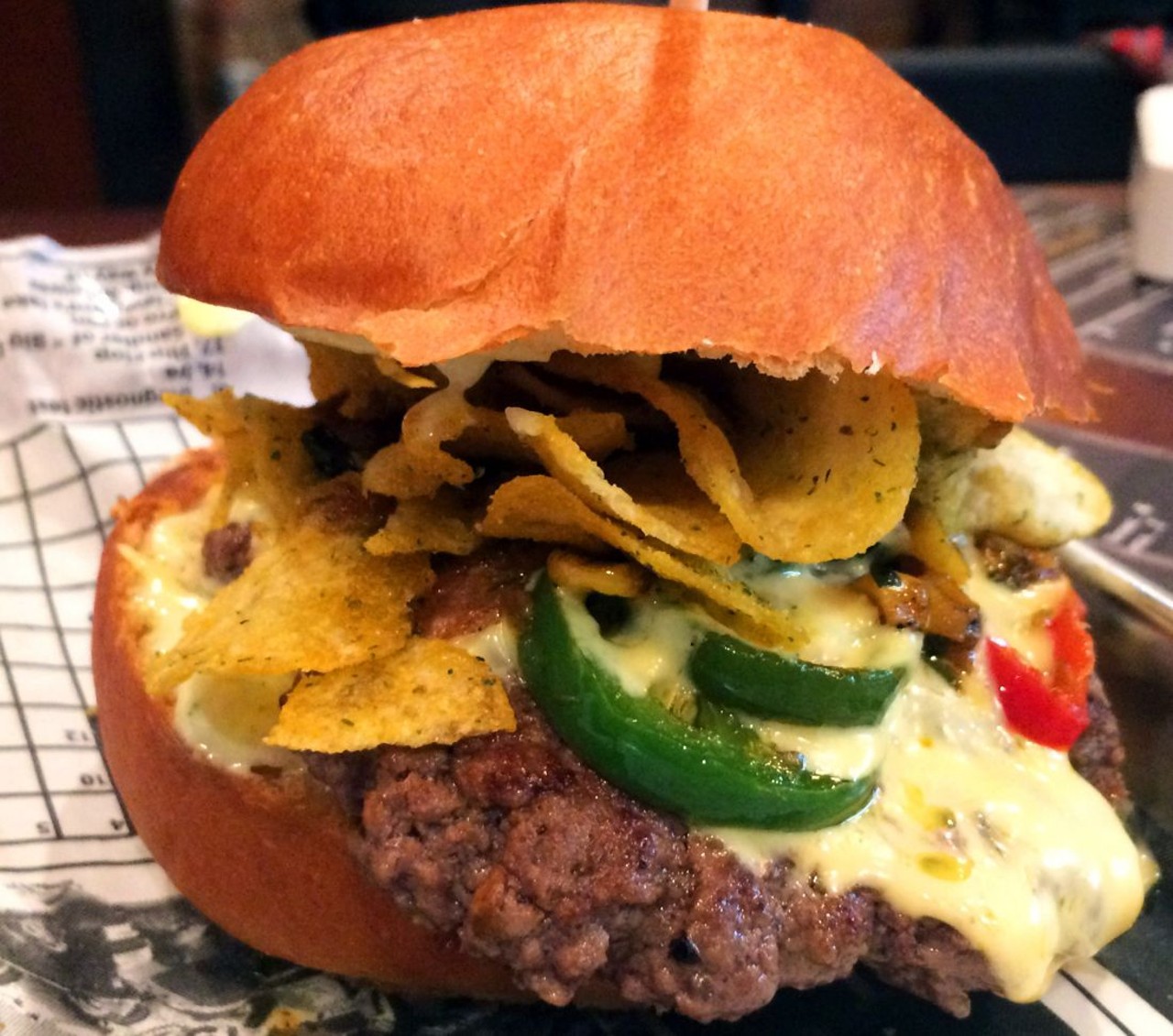 "The Kruncher" with roasted green chile queso, southwest corn relish, cajun aioli, and Kruncher jalapeno potato chips.