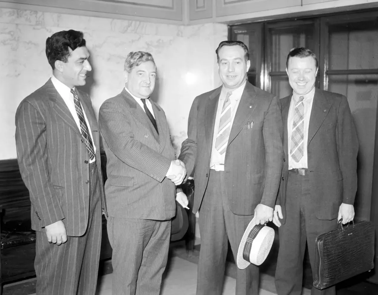  Aug. 5, 1939: Officers George F. Addes, James F. Dewey, R.J. Thomas, and Walter P. Reuther with papers, signed by officers of GM ending tool and die strike.