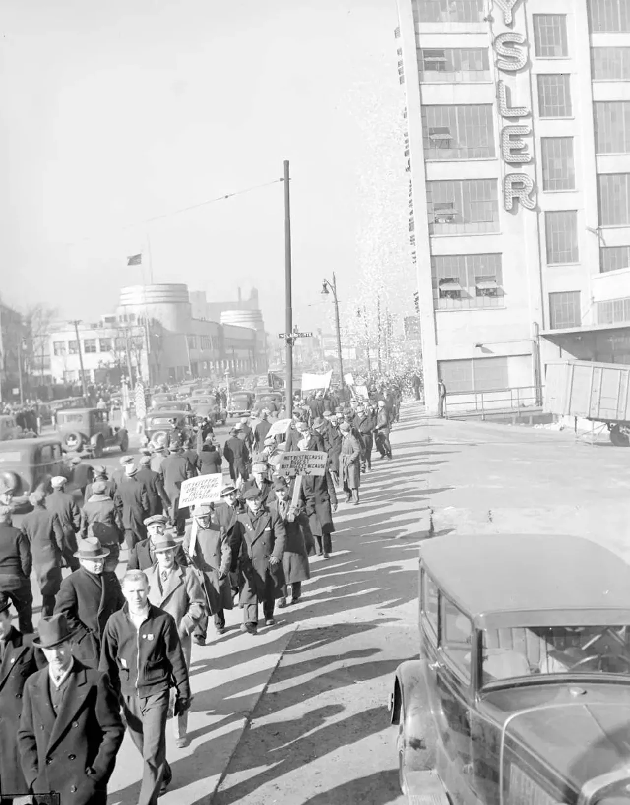  March 17, 1937: Striking auto workers walk a picket line near the Chrysler plant on Jefferson Avenue in Detroit.