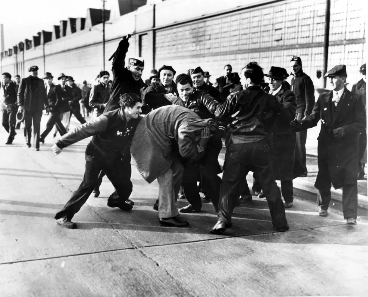  April 3, 1941: Violent scene of UAW members attacking a man trying to cross a picket line at Ford Motor Company in Dearborn. This photograph taken by Detroit News photographer Milton Brooks won the first Pulitzer Prize for photography in 1942.