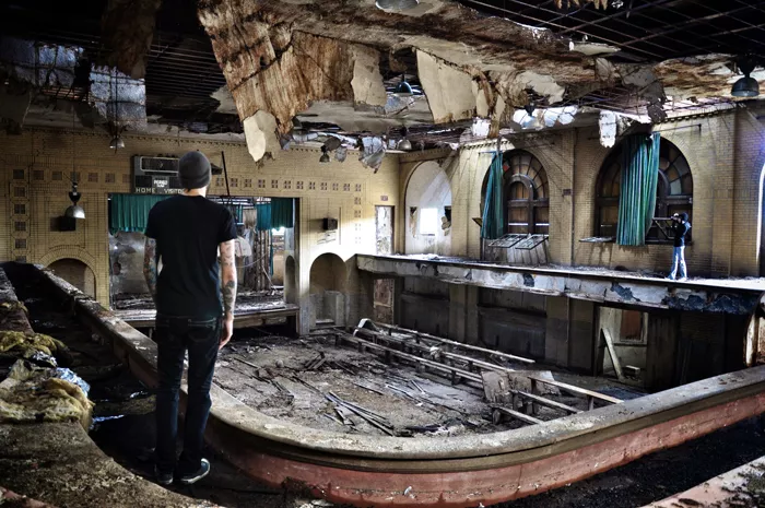 Seph Lawless examines a typical Detroit ruin. - Photo courtesy of Seph Lawless.