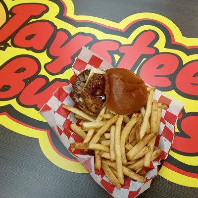  On that note, Taystee’s fries may be better than any I’ve sampled as either a professional eater or a 61-year-old who’s enjoyed more than his share of “French”-fried potatoes in life. They’re $3.99 for a basket big enough to fill half a bushel, and they’re spectacularly skin-on crisp, fresh, and piping hot. Seasoning options are up to you. While I’m a salt and pepper purist, there’s also ranch or lemon pepper. Then there’s the burgers themselves: big, juicy, and nestled between soft, toasty buns of buttery brioche. Taystee’s Hawaiian ($10.49) has fresh-grilled pineapple and caramelized onion painted with a piquant teriyaki glaze and a gooey blanket of Pepper Jack, tasting every bit as delicious as that all sounds together. Simpler, my Mushroom Swiss model ($9.99) also sings, gilded with those same griddled onions, lettuce, tomato, mayo, and ketchup. Assortments of adornment options aside (pizza toppings, a spicy “Volcano” version, Mac N Cheesed, et al., $10.99-$14.99), Taystee’s is more about quality meat and bread, and while some in my circle beef a bit about the price of a burger with fries here ($15-$20), these are the prices we’re paying nowadays, folks (sorry, last time). My one critical takeaway along those lines — for what it’s worth — is that half the fries for half the price is something Taystee’s might consider from a customer’s value perception perspective. Too much for too much is too much. I get they’re shareable, but how many customers come in alone, capisce? Sides are a different story, and Taystee’s offers reasonably-priced onion rings, poppers, cheese sticks, and such. But fries are still a throw-in in the minds of many. Just sayin’. Truly, the gas station business model has evolved since my boyhood back in the 20th century. Honestly, what will they think of next, hover-thru for those air cars we’ve been hearing about since that Rush album? It boggles this old stoner’s mind. More good gas station eats: