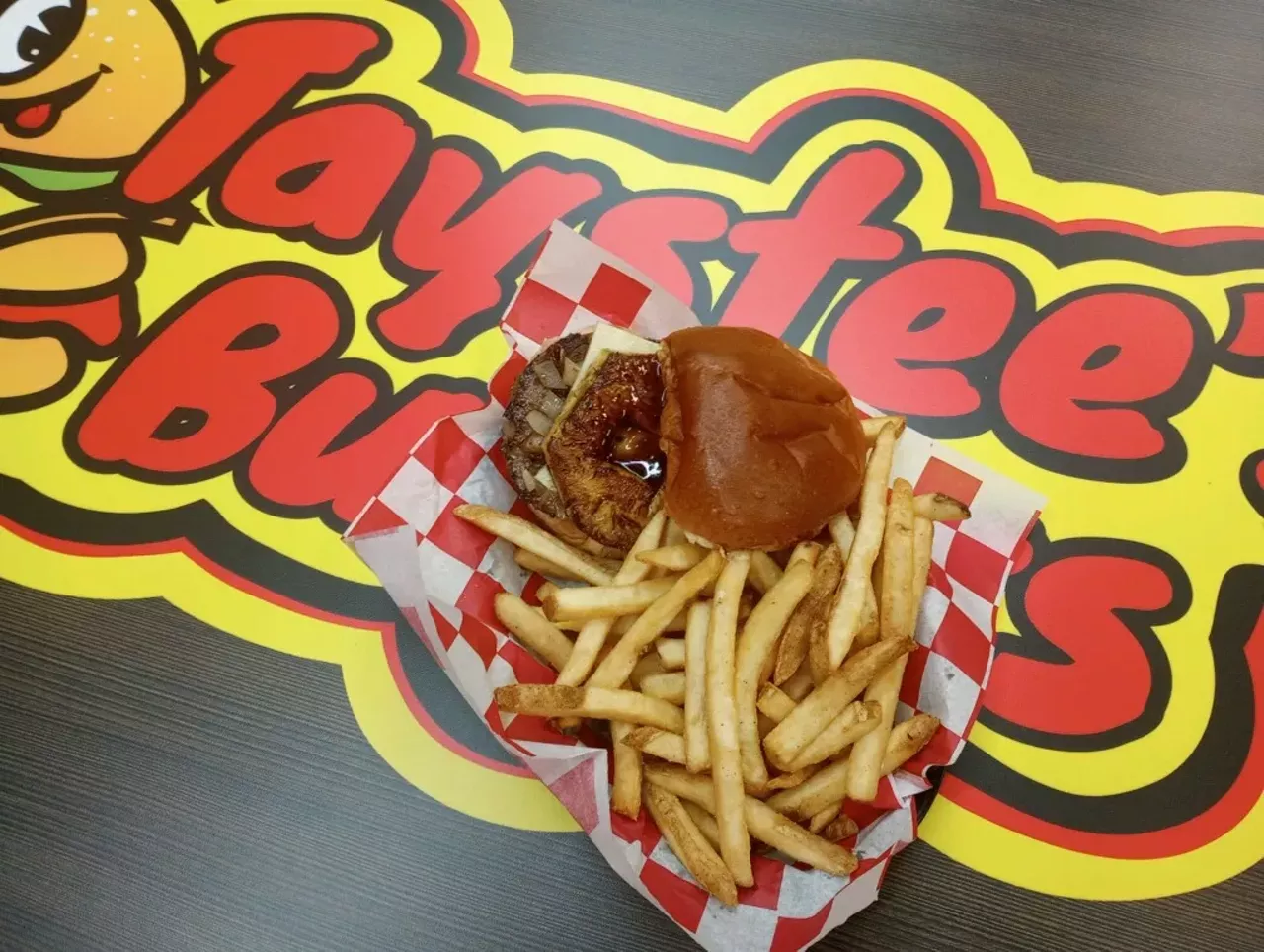  On that note, Taystee’s fries may be better than any I’ve sampled as either a professional eater or a 61-year-old who’s enjoyed more than his share of “French”-fried potatoes in life. They’re $3.99 for a basket big enough to fill half a bushel, and they’re spectacularly skin-on crisp, fresh, and piping hot. Seasoning options are up to you. While I’m a salt and pepper purist, there’s also ranch or lemon pepper. Then there’s the burgers themselves: big, juicy, and nestled between soft, toasty buns of buttery brioche. Taystee’s Hawaiian ($10.49) has fresh-grilled pineapple and caramelized onion painted with a piquant teriyaki glaze and a gooey blanket of Pepper Jack, tasting every bit as delicious as that all sounds together. Simpler, my Mushroom Swiss model ($9.99) also sings, gilded with those same griddled onions, lettuce, tomato, mayo, and ketchup. Assortments of adornment options aside (pizza toppings, a spicy “Volcano” version, Mac N Cheesed, et al., $10.99-$14.99), Taystee’s is more about quality meat and bread, and while some in my circle beef a bit about the price of a burger with fries here ($15-$20), these are the prices we’re paying nowadays, folks (sorry, last time). My one critical takeaway along those lines — for what it’s worth — is that half the fries for half the price is something Taystee’s might consider from a customer’s value perception perspective. Too much for too much is too much. I get they’re shareable, but how many customers come in alone, capisce? Sides are a different story, and Taystee’s offers reasonably-priced onion rings, poppers, cheese sticks, and such. But fries are still a throw-in in the minds of many. Just sayin’. Truly, the gas station business model has evolved since my boyhood back in the 20th century. Honestly, what will they think of next, hover-thru for those air cars we’ve been hearing about since that Rush album? It boggles this old stoner’s mind. More good gas station eats: