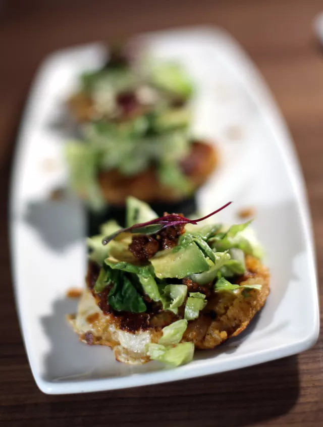 Spanish yapingacho: Potato cakes stuffed with queso blanco, avocado, peanut sauce and chorizo.