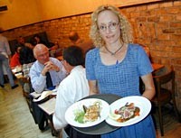 Streetside Seafood manager Tracy Goralski serves crab cakes and seared tuna appetizers. - METRO TIMES PHOTO / LARRY KAPLAN