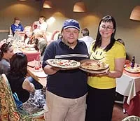 Terra Cotta: Co-owners Greg and Dina Gnyp serve Olivinia pizza and a ham-and-cheese calzone. - Metro Times Photo / Larry Kaplan