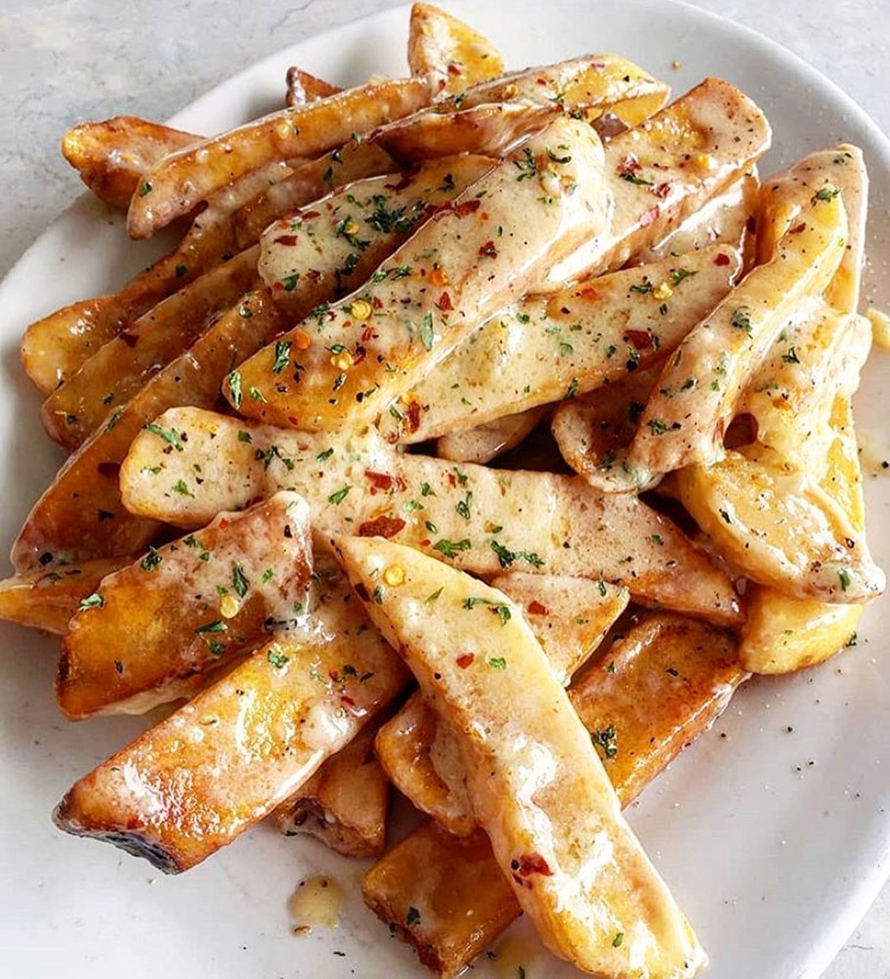 Eddie’s Gourmet 
25920 Greenfield Rd., Oak Park; 248-968-4060; eddiesgourmetmi.com
The Hawaiian fries at Eddie’s Gourmet are a unique creation of fries topped with a special buttery sauce, red pepper flakes, and parsley. If you visit the Oak Park restaurant, you must try them. 