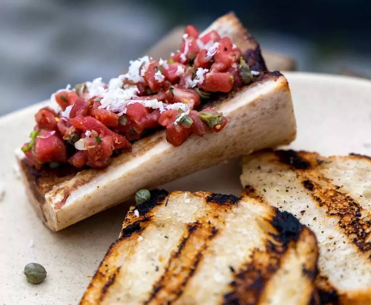 Carne y hueso at Barda 
Chef Javier Bardauil opened his Argentinean steakhouse in the former Magnet spot and has quickly made a name for himself with bangers like the carne y hueso, a plate of hot bone marrow and cold beef tartare. The marrow is as it should be: viscous, rich, and fatty, while the tartare's striploin is mixed with capers, garlic, onion, jalape&ntilde;o, whole grain mustard seed, lemon, olive oil, plenty of salt, and a smear of horseradish &#151; intense. Even the bread is amped up and meaty as Barda makes tallow that's brushed on the toast. (4842 Grand River Ave., Detroit; 313-952-5182; bardadetroit.com)
&#151;Tom Perkins
Photo by Emma Sandler