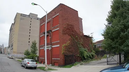 The house behind the building can be easily seen now that the home's old neighbors are gone. - Andrew Erdmann