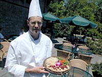 The Pool's executive chef, Peter Veach, serves planked whitefish with cherries and almonds. - METRO TIMES PHOTO / LARRY KAPLAN