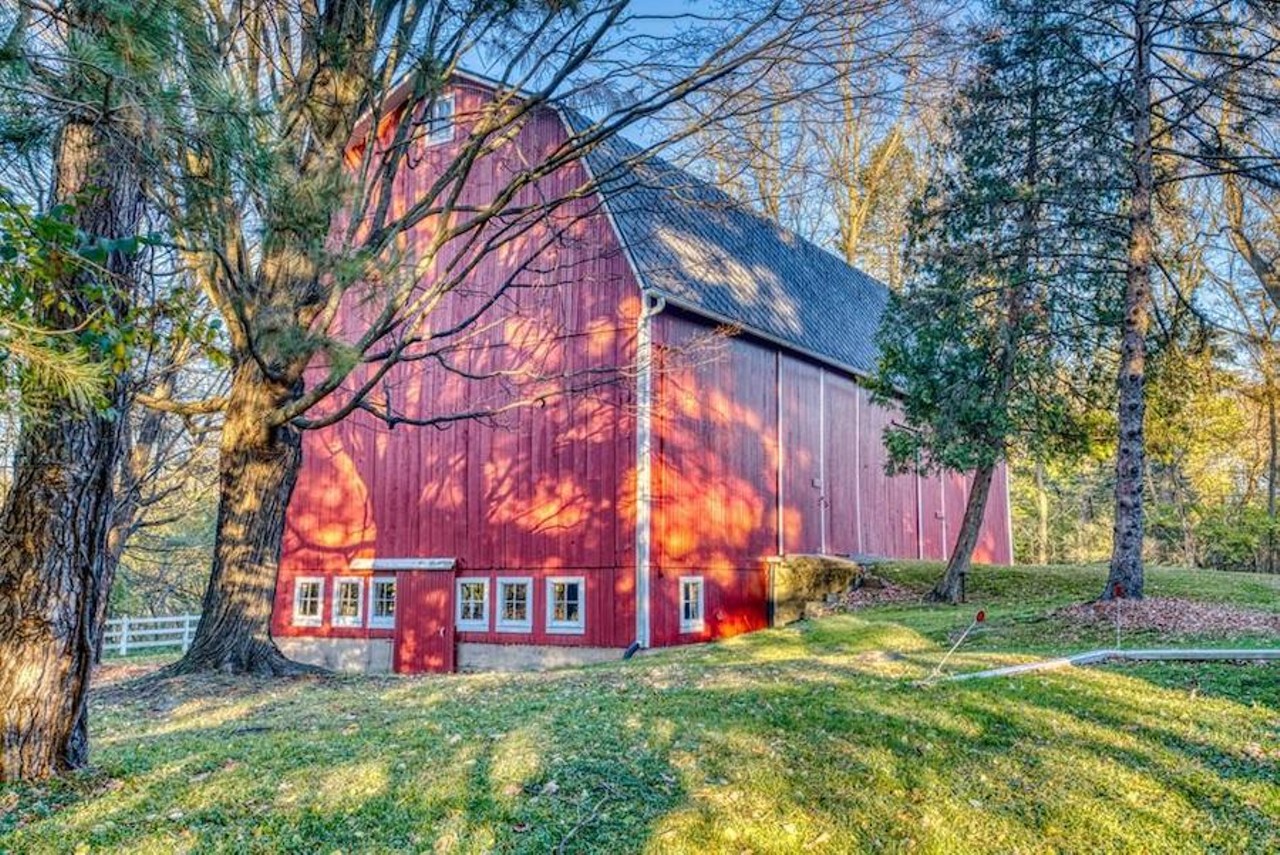 This historic Mid-Century Modern farmhouse in Okemos includes a barn and carriage house