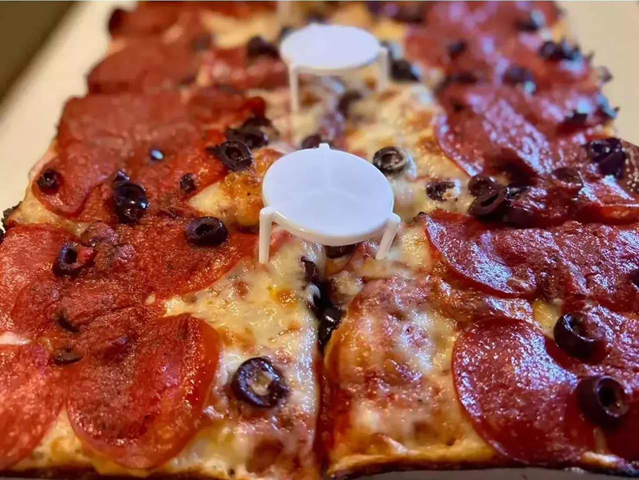 #24 Belle Isle Pizza 7869 E. Jefferson, Detroit; belleislepizza.com Belle Isle Pizza has been serving pies from a small, no-frills spot near Belle Isle since 2015. Under new ownership since 2023, their Detroit-style pizza is straightforward but falls short of the city&rsquo;s best. The crust is thinner than most Detroit-style pies, and while the edges have a satisfying crunch, the overall structure lacks heft. The tangy sauce leans acidic, which overpowers the cheese instead of balancing it. The flavor is there, but the execution felt a bit off. Still, it was a decent, satisfying pizza, but in a city with so many good options, this one doesn&rsquo;t quite measure up.