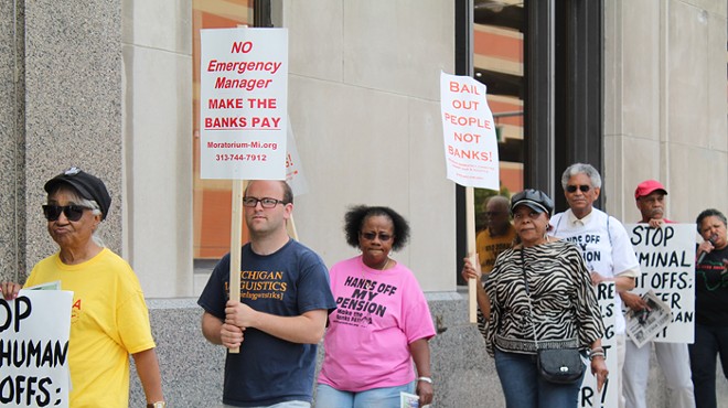 A coalition of activists protests outside the Detroit Water & Sewerage Department’s office in downtown Detroit on Friday, June 6.