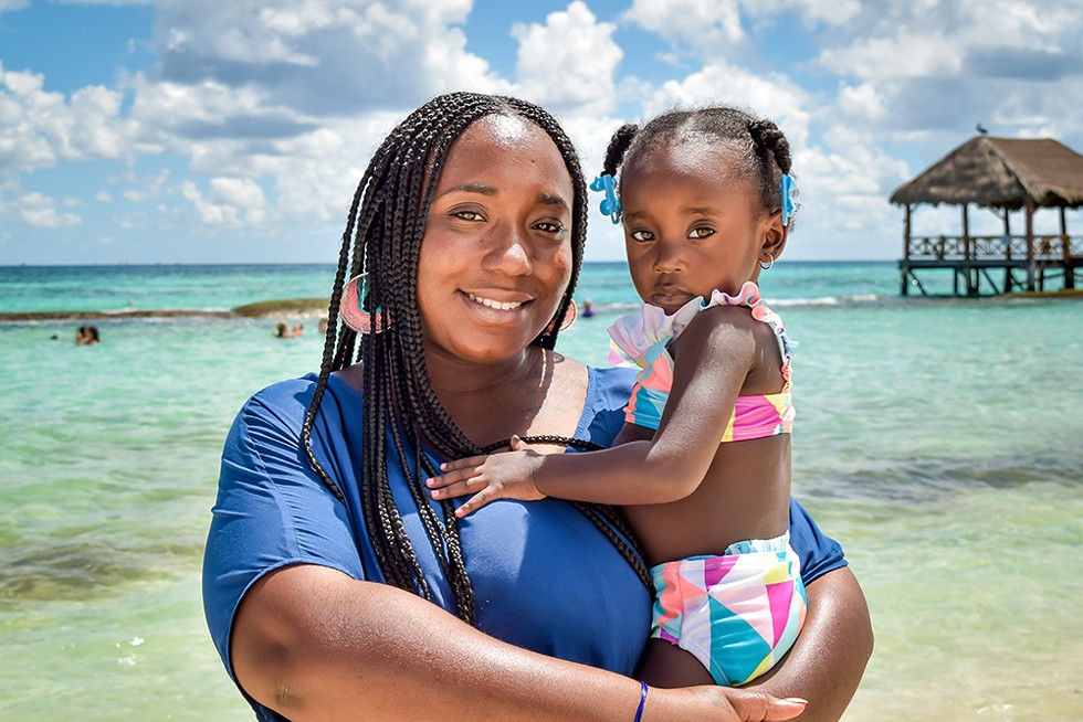 Siwatu-Salama Ra and her daughter pictured on vacation. Ra is now pregnant with her second child and imprisoned for a mandatory minimum sentence on gun-related charges. Her defense says she was acting in self defense. - COURTESY PHOTO