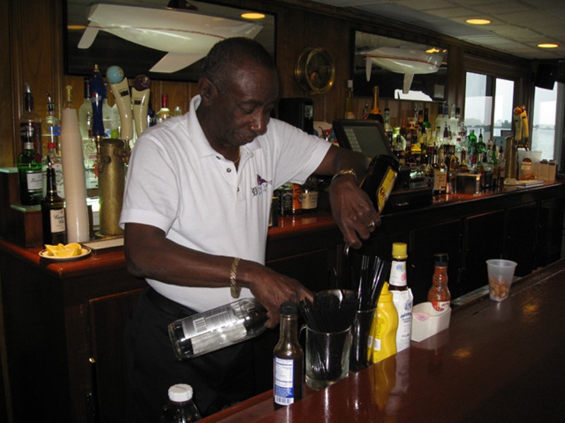 Jerome Adams mixes his signature drink behind the bar at Bayview Yacht Club. - PHOTO BY MICHAEL JACKMAN