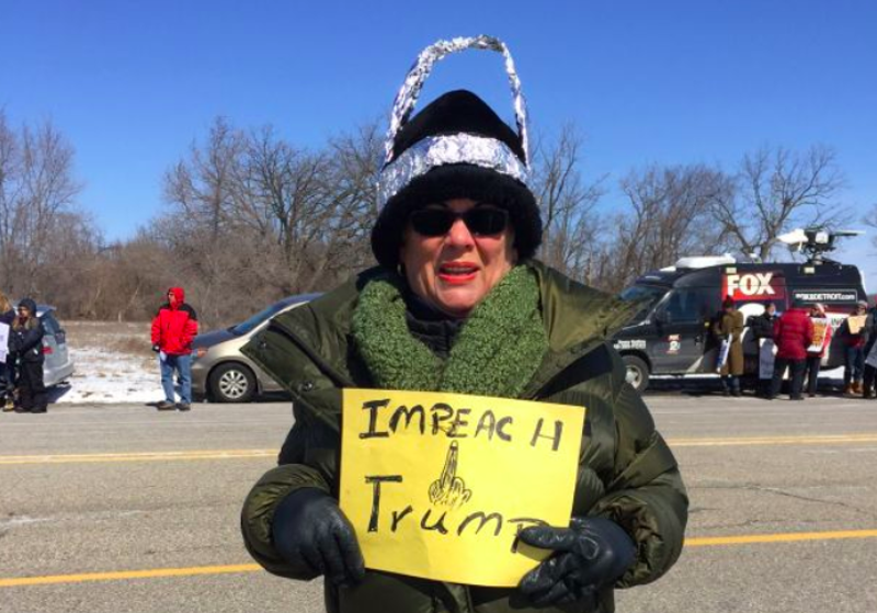 Woman in a tin hat protesting Trump's visit to Ypsilanti last year. - VIOLET IKONOMOVA