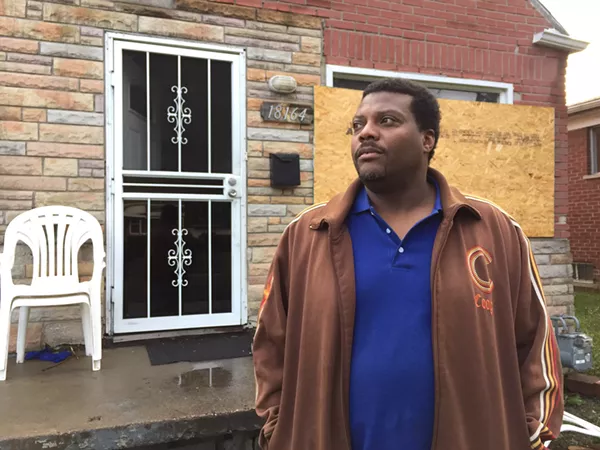 Kevin Dickerson in front of his Detroit home the day after it sold in the Wayne County tax foreclosure auction. He and his family of four were living under the federal poverty line when the home was foreclosed, but they had been unable to obtain the poverty tax exemption. - Violet Ikonomova