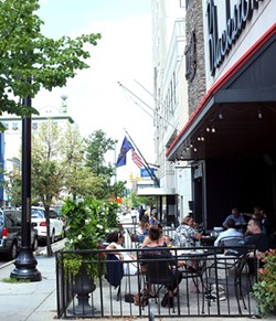 Lunchtime diners hang out on the outdoor patio at Blackstone's Pub& Grill in downtown Flint. - Scott Atkinson