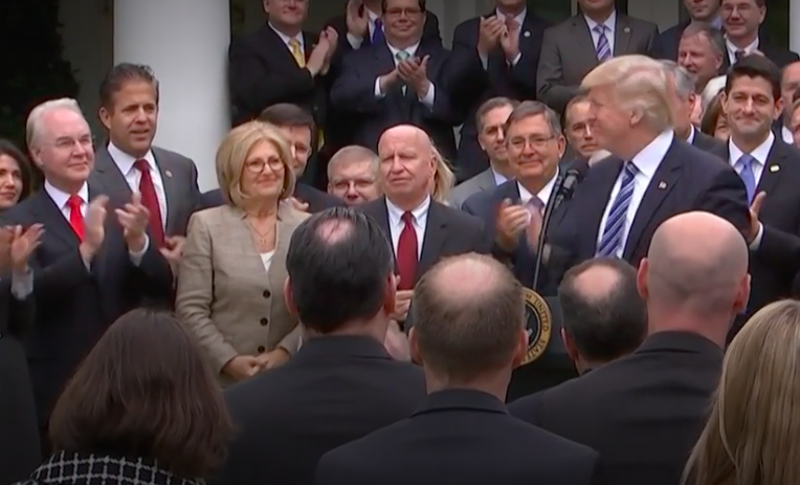 Mike Bishop — tan dude on left — literally "smiling at the White House" after voting to repeal the law that helped an additional 20 million Americans obtain health insurance. - Screengrab, Youtube