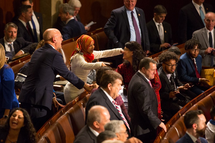 Rep. Ilhan Omar, the only other Muslim woman elected to Congress, reaches out to hug Tlaib as Pelosi concludes the ceremony. - Erik Paul Howard