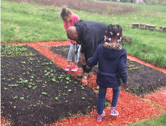 Marc Peeples working with children on Liberated Farms. - Photo courtesy of Liberated Farms