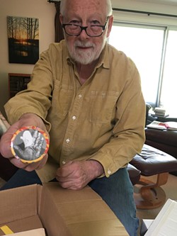 Ken Mikolowski, holding a button depicting poet Jim Gustafson’s bandaged hand, will give a talk commemorating the 50th anniversary of the Alternative Press. - Courtesy of Meredith Counts