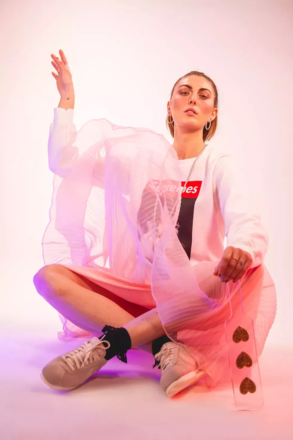 Impact play: Supremes crewneck sweatshirt, $60, SMFLD, 313-285-9564, buy.smplfd.com; Cortez sneakers, Nike, $90, 313-965-3319, nike.com; Pink Dream dress, $68, Shop Minnie Lou, @shopminnielou, 1418 Michigan Ave., Detroit; black ankle socks, $4.50, 248-541-3979; noirleather.com; diamond necklace, $27,000, hoop earrings, $999.99, pink studs, $1,499, multi-colored ring, $1,599, New World Diamonds, newworlddiamonds.com; heart paddle, $42, eatdarich.com. - Miles Marie of Nomadic Madam