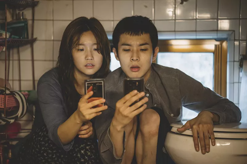 Ki-jung Kim (So-dam Park) and Ki-woo Park (Woo-sik Choi) in Parasite. - Courtesy of NEON CJ Entertainment