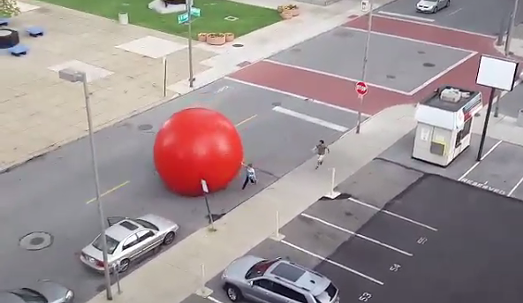 WATCH: 250-pound red ball art installation goes rogue, rolls through Toledo streets