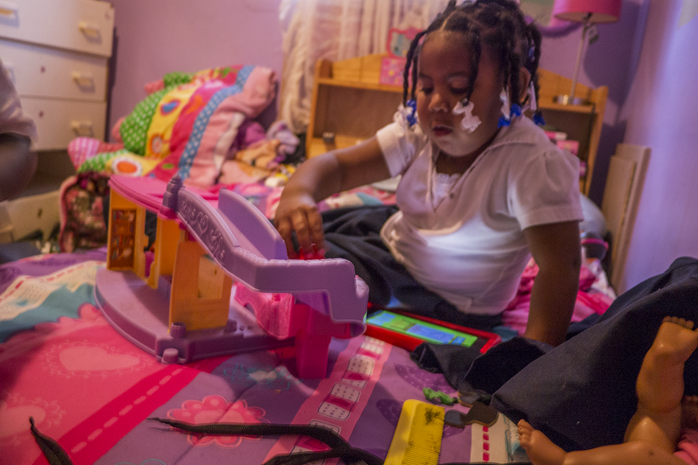Robertson's daughter Kyi'Lei plays with toys in her bedroom. - IAIN MAITLAND