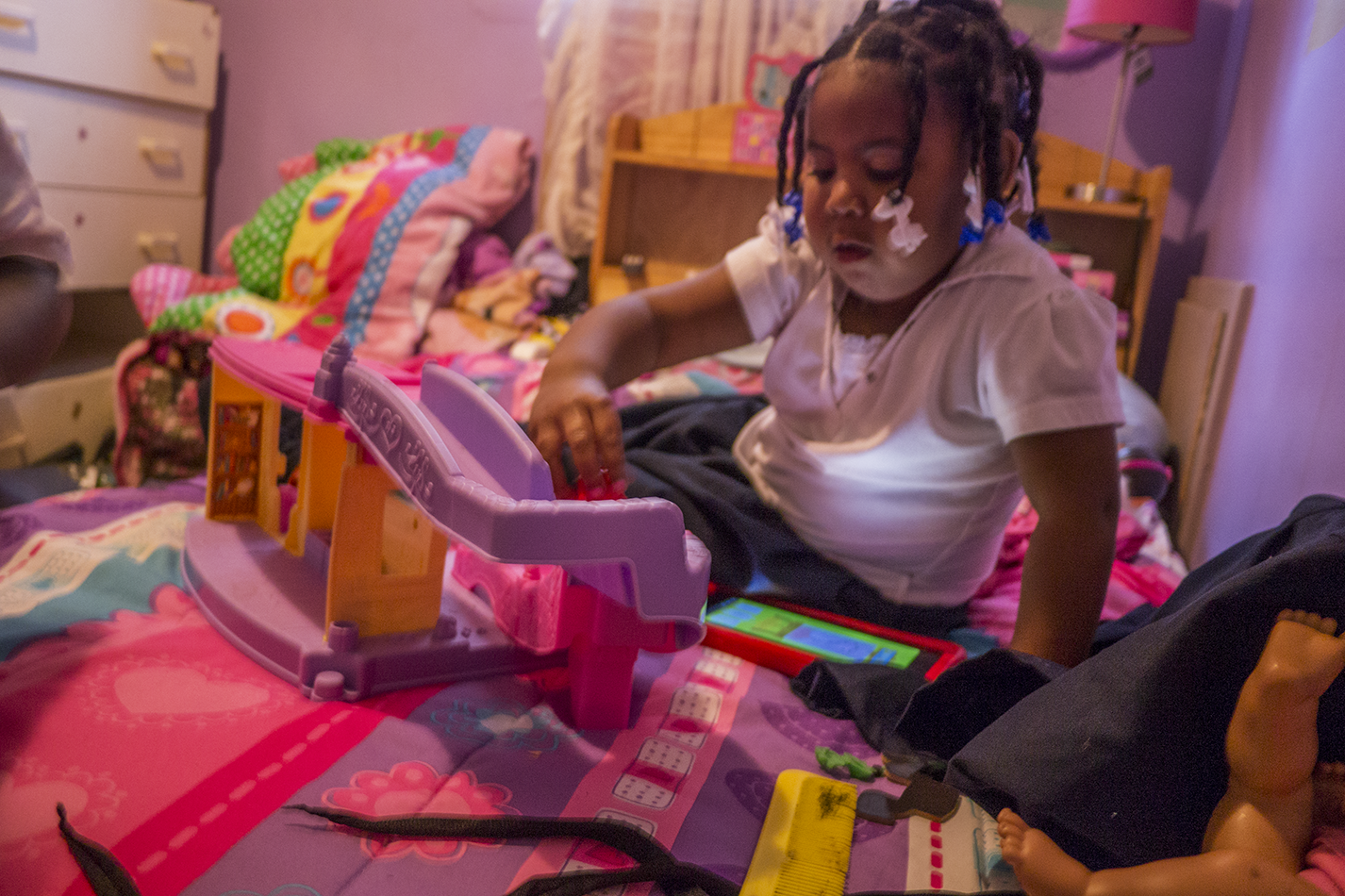 Robertson's daughter Kyi'Lei plays with toys in her bedroom. - Iain Maitland