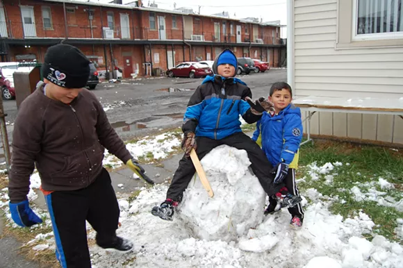 Alrashdan's children playing in the season’s first snow, a novelty they relish in a way no lifelong Michigander ever would. - Don Jordan