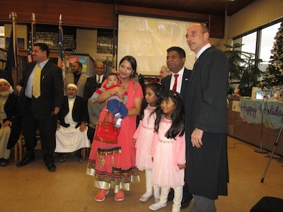 The Musa family poses with Judge Paruk.