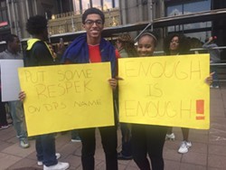 "I'm inspired. It's good to see people come together and fight for what they believe in. Nobody should work without getting paid," says Paris, a senior at Cass Tech, as she rallies with her mom Tamika Morgan and younger brother Milton. - Allie Gross